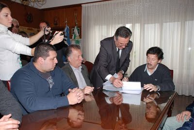 El intendente Posse firmando ante el titular de la línea 33 y los representantes de los trabajadores el convenio que permitirá a la empresa seguir operando en el puerto El intendente Posse firmando ante el titular de la línea 33 y los representantes de los trabajadores el convenio que permitirá a la empresa seguir operando en el puerto